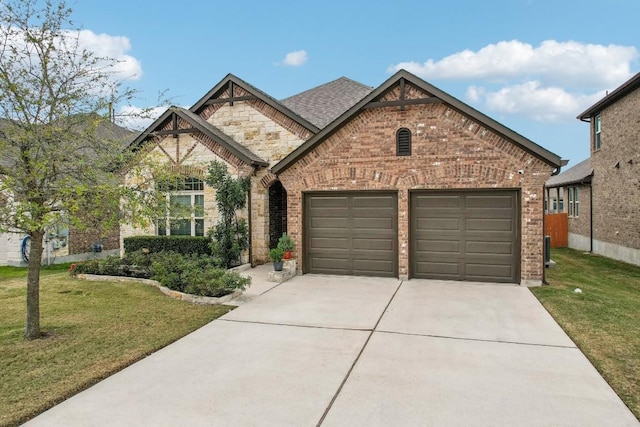 view of front of home with a garage and a front lawn