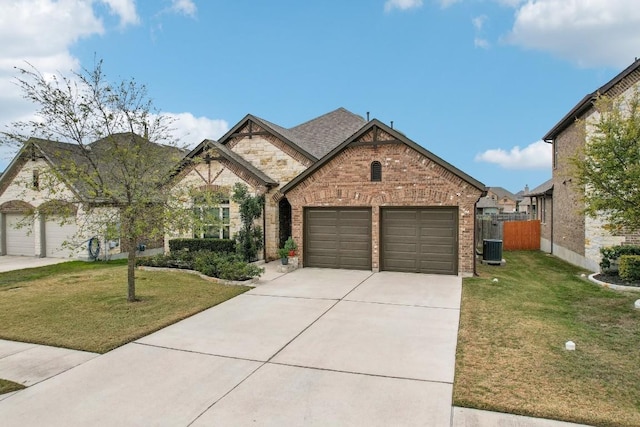 view of front of house with a front yard, a garage, and central AC unit