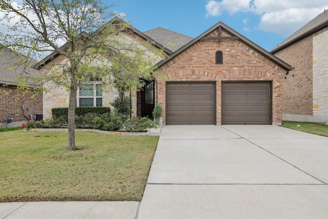 view of front of house with a garage and a front lawn