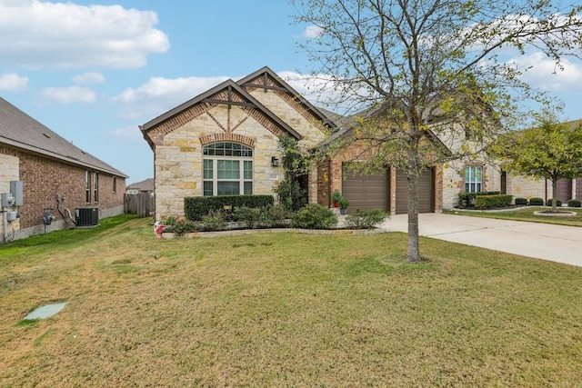 view of front of house with cooling unit, a front yard, and a garage