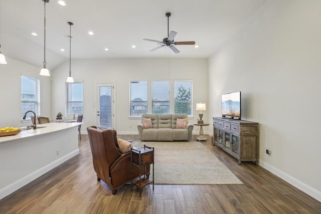 living room with vaulted ceiling, ceiling fan, and sink