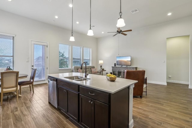 kitchen with a kitchen island with sink, hanging light fixtures, sink, stainless steel dishwasher, and ceiling fan