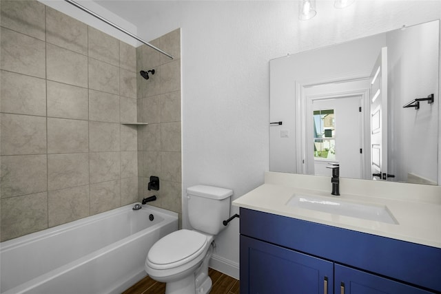 full bathroom featuring vanity, toilet, wood-type flooring, and tiled shower / bath