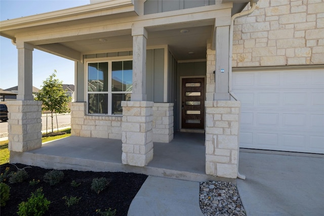 property entrance with covered porch and a garage