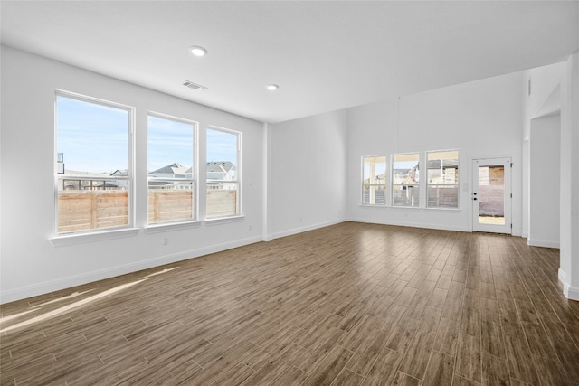 unfurnished living room featuring dark hardwood / wood-style flooring