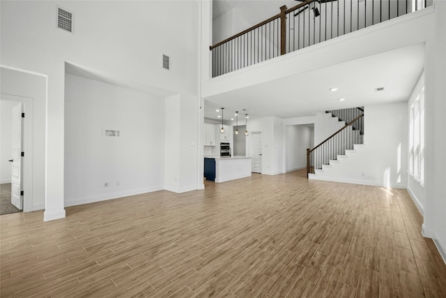 unfurnished living room with a high ceiling