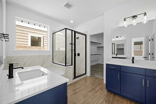 bathroom featuring vanity and an enclosed shower