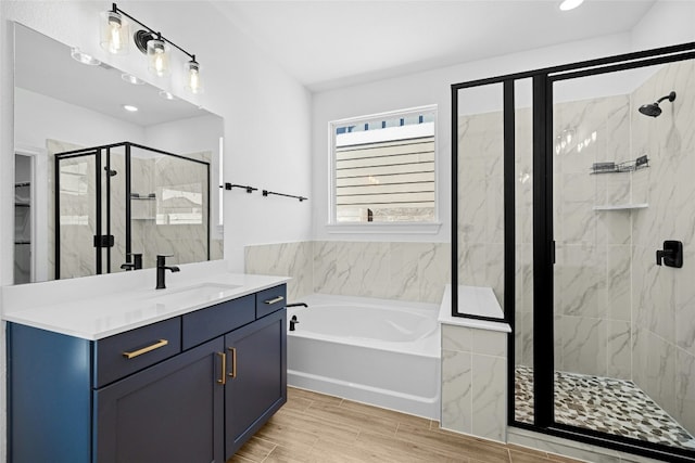 bathroom featuring vanity and separate shower and tub