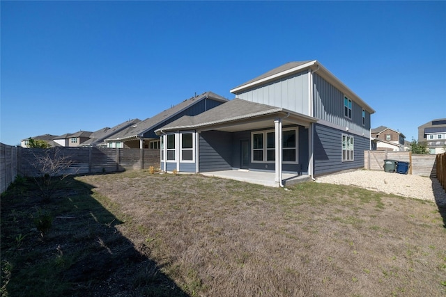 rear view of house with a patio area and a yard