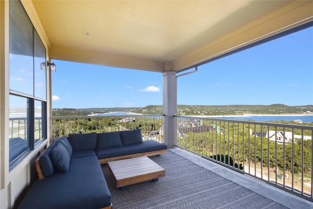 balcony with outdoor lounge area and a water view