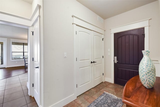 foyer featuring light tile patterned flooring