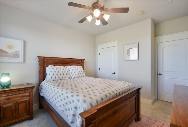 bedroom featuring ceiling fan and light colored carpet