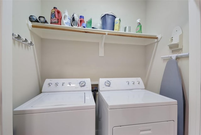 clothes washing area featuring separate washer and dryer