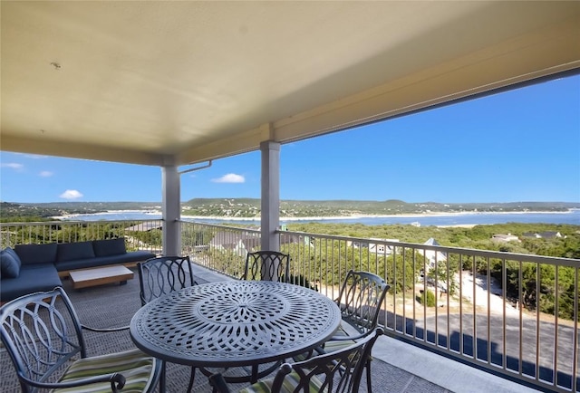 view of patio with a beach view, an outdoor hangout area, a water view, and a balcony