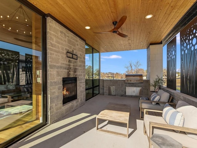 view of patio with an outdoor stone fireplace, an outdoor kitchen, ceiling fan, and a grill