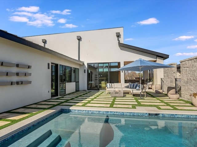 back of property featuring outdoor lounge area and a patio area