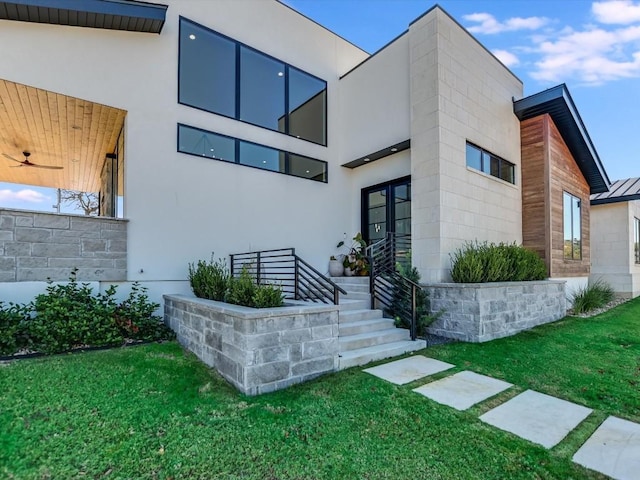 entrance to property with a lawn