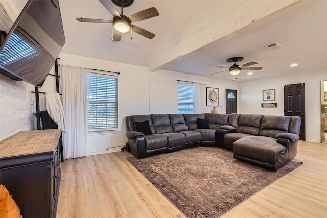 living room with light hardwood / wood-style flooring, ceiling fan, and lofted ceiling