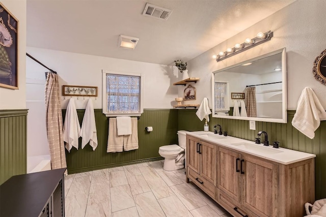 bathroom featuring a shower with shower curtain, vanity, and toilet