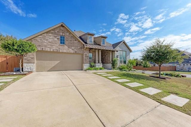 view of front of property featuring a front yard and a garage