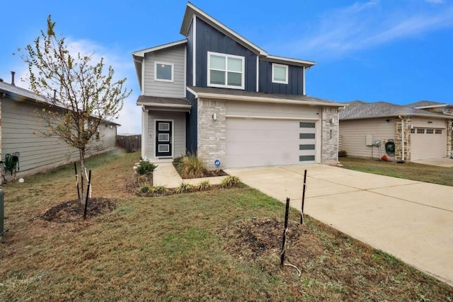 view of front of property featuring a garage and a front lawn