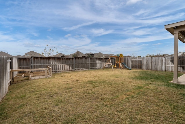 view of yard featuring a fenced backyard and a playground