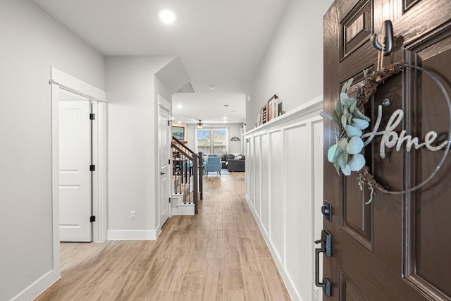 foyer entrance with stairs, recessed lighting, a ceiling fan, and light wood finished floors