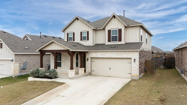 view of front of home with a garage, covered porch, and a front lawn