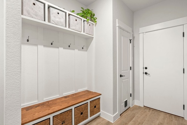 mudroom with light wood finished floors