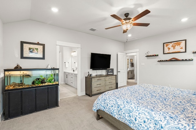 bedroom featuring visible vents, light colored carpet, lofted ceiling, recessed lighting, and ensuite bathroom