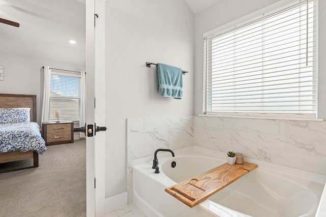 ensuite bathroom featuring a bath and ensuite bathroom