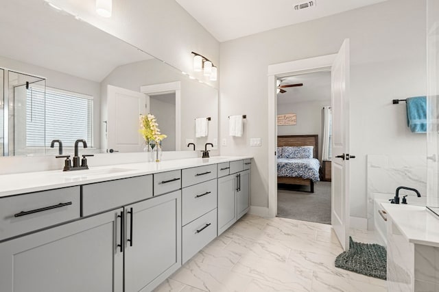 full bathroom featuring double vanity, marble finish floor, a ceiling fan, and a sink