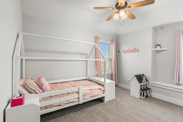 carpeted bedroom with baseboards and a ceiling fan