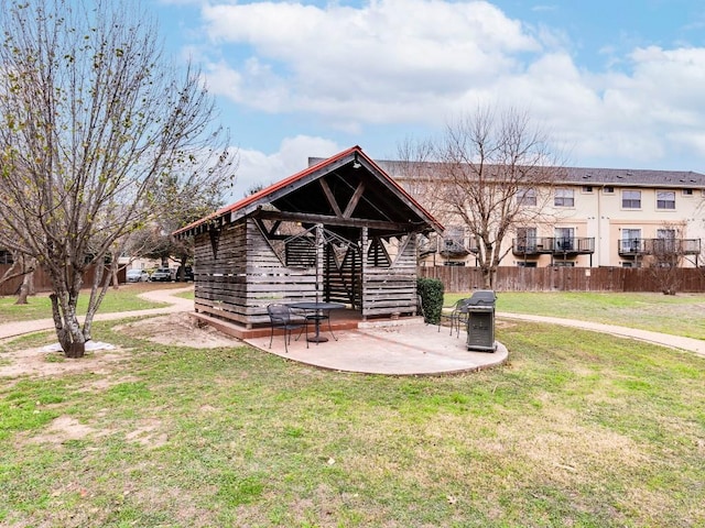 view of front of property with a patio area and a front lawn