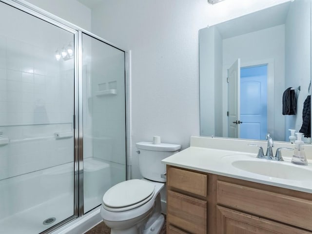 bathroom featuring toilet, an enclosed shower, and vanity