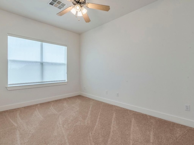 carpeted spare room featuring ceiling fan