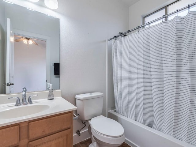 full bathroom with vanity, toilet, ceiling fan, and shower / tub combo with curtain