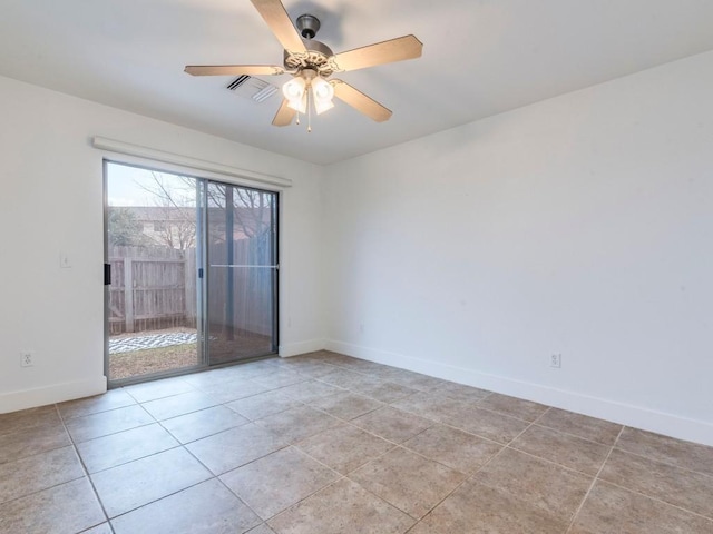 tiled spare room with ceiling fan