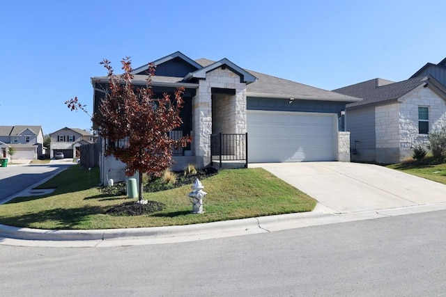 view of front of property with a garage and a front lawn