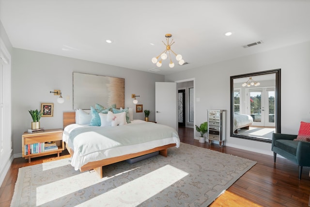 bedroom with an inviting chandelier, hardwood / wood-style floors, and french doors