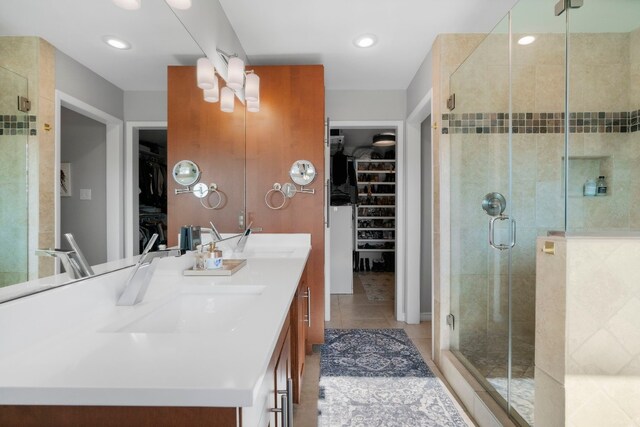 bathroom featuring vanity, tile patterned floors, and walk in shower