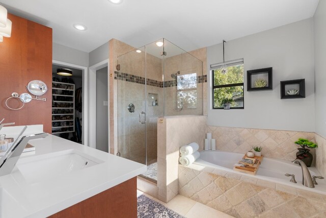 bathroom with tile patterned flooring, plus walk in shower, and vanity