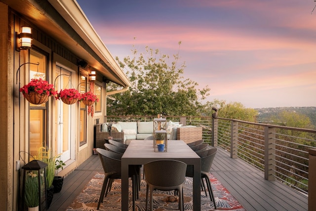 deck at dusk featuring an outdoor hangout area