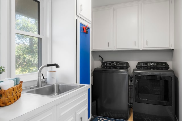 laundry area featuring sink, cabinets, and washing machine and clothes dryer