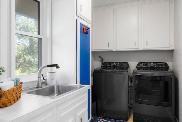 laundry area with cabinets, sink, and washing machine and dryer