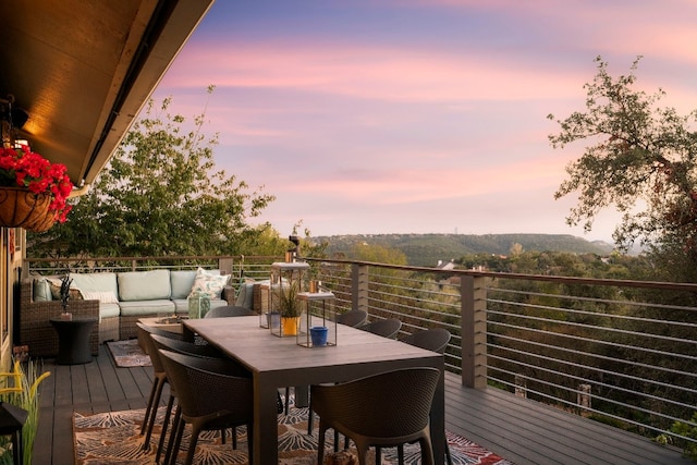 deck at dusk with an outdoor hangout area