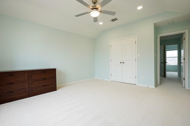 carpeted bedroom with vaulted ceiling, ceiling fan, and a closet