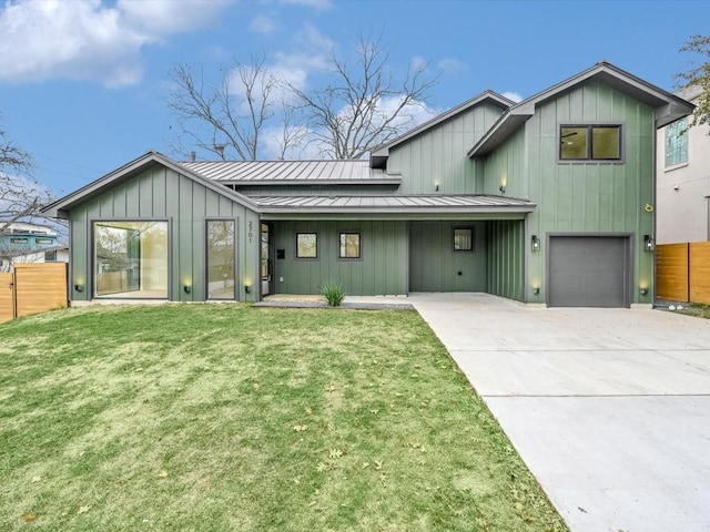 modern inspired farmhouse with a garage and a front lawn