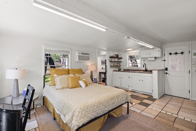 bedroom featuring a sink and a wall mounted air conditioner