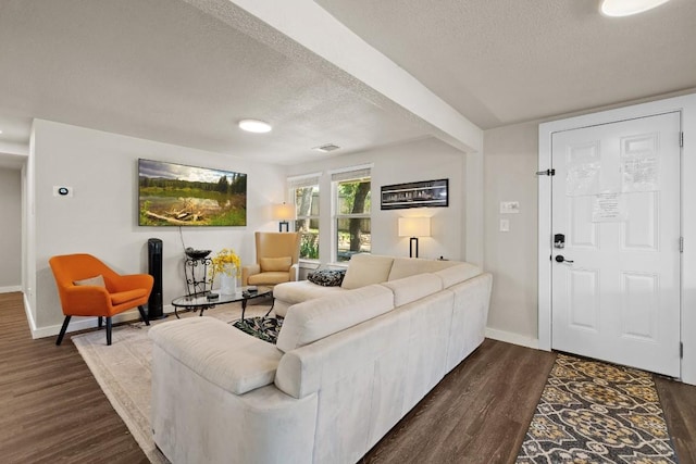 living area featuring a textured ceiling, baseboards, and dark wood-style flooring